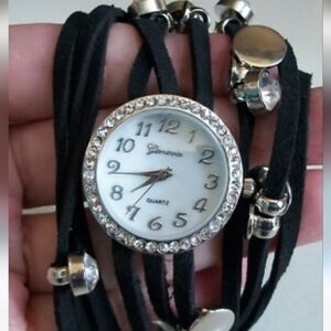 women's fashion wrap-around watch with a black suede or faux suede strap and gol